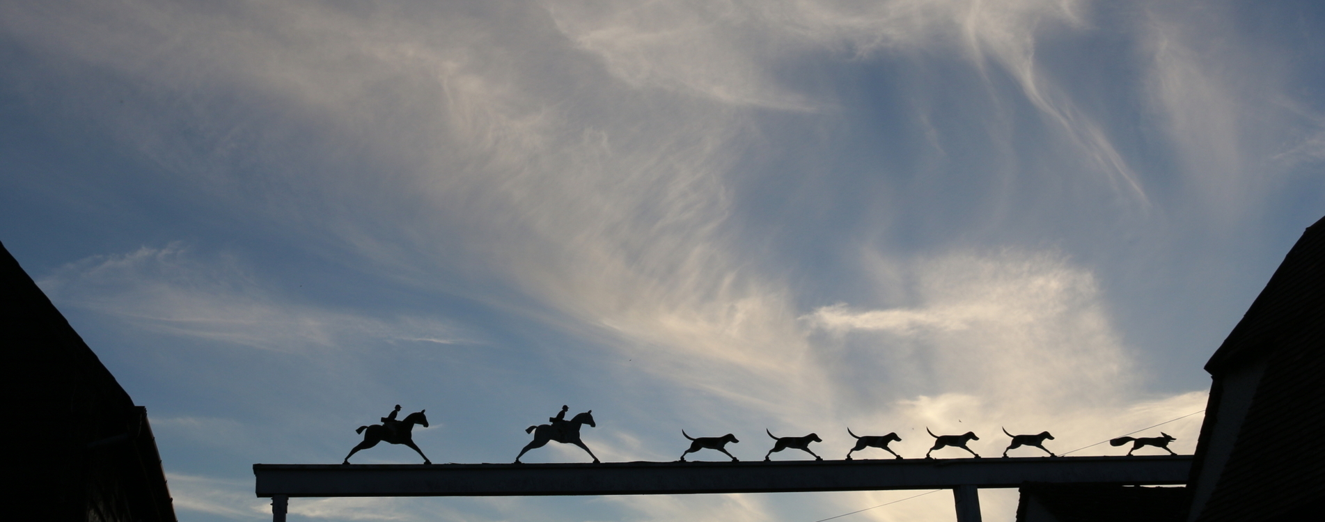 the iconic Fox and Hounds sign against a bright night sky
